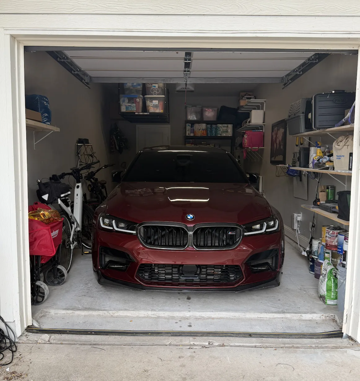 Car parked inside a clean, organized single-car garage after professional cleanout