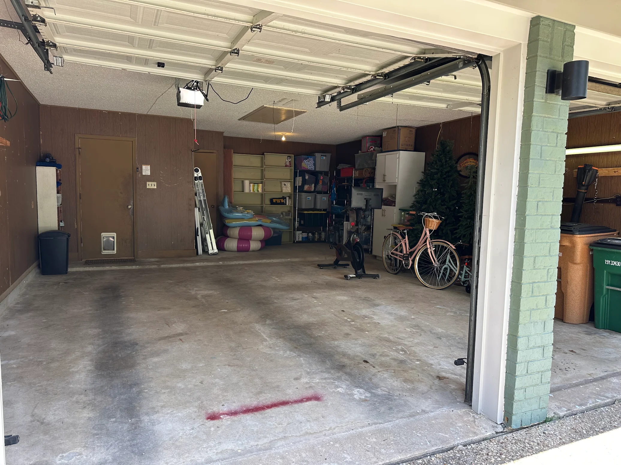 Clean organized garage with shelving and bicycle after cleanout
