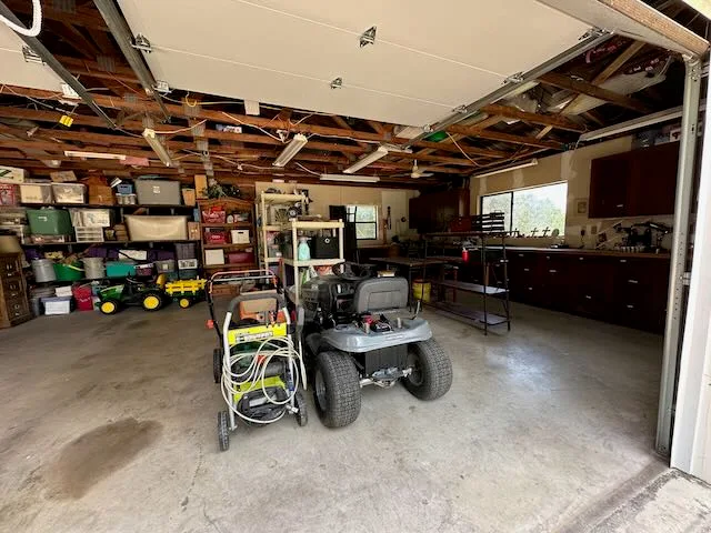 Clean garage with organized shelving and equipment neatly stored after cleanout
