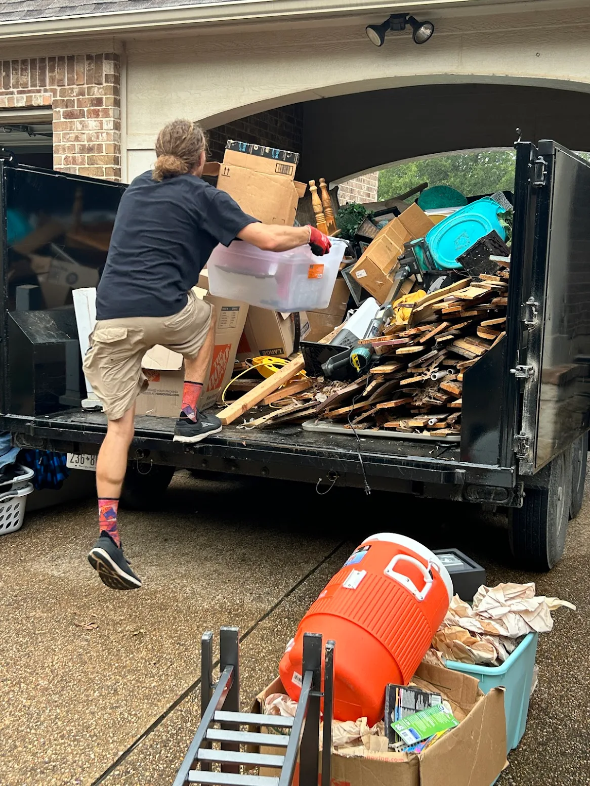 Crew loading a dump trailer on a junk removal job