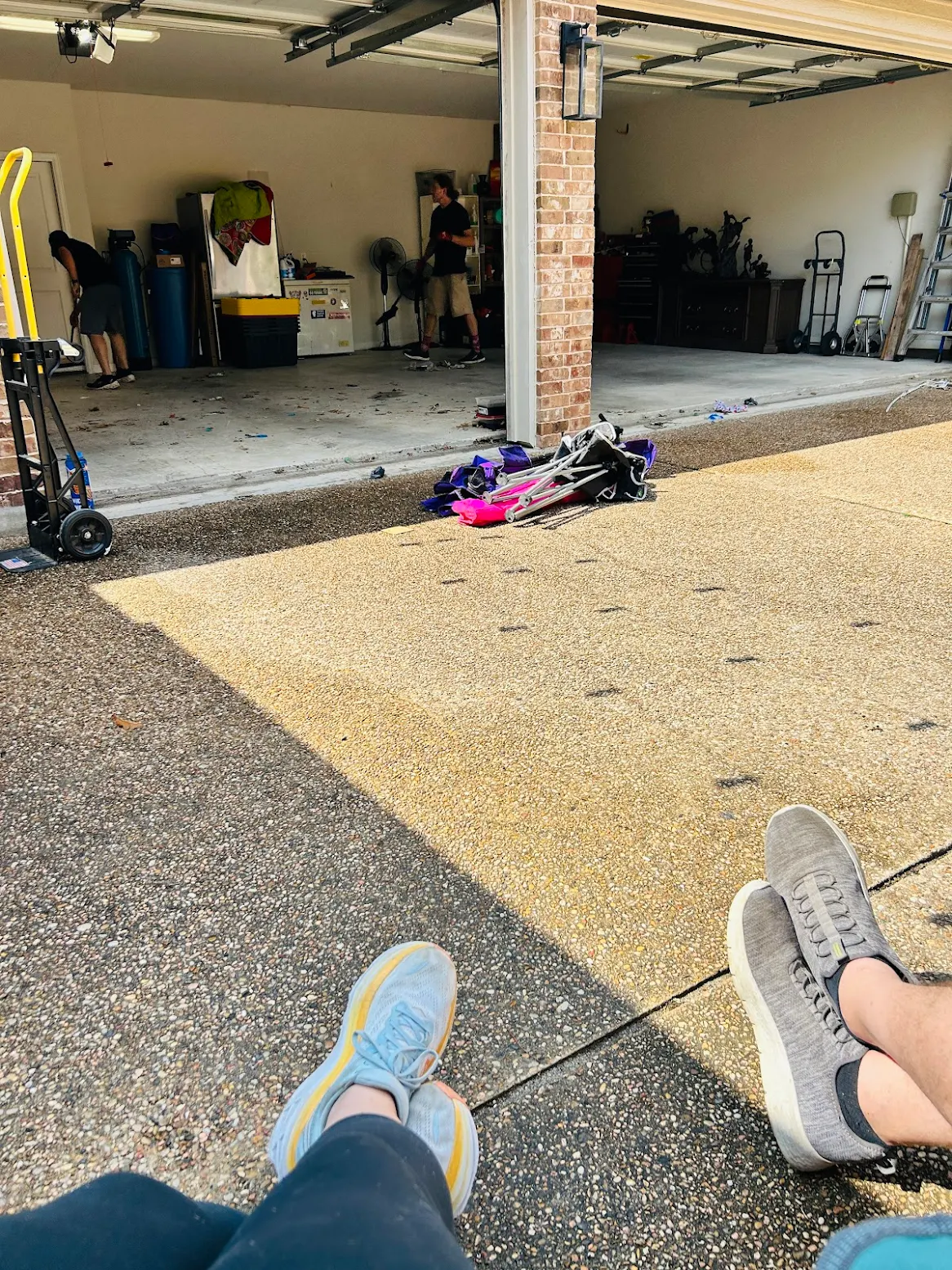 A family relaxing in the driveway while the crew clears their garage