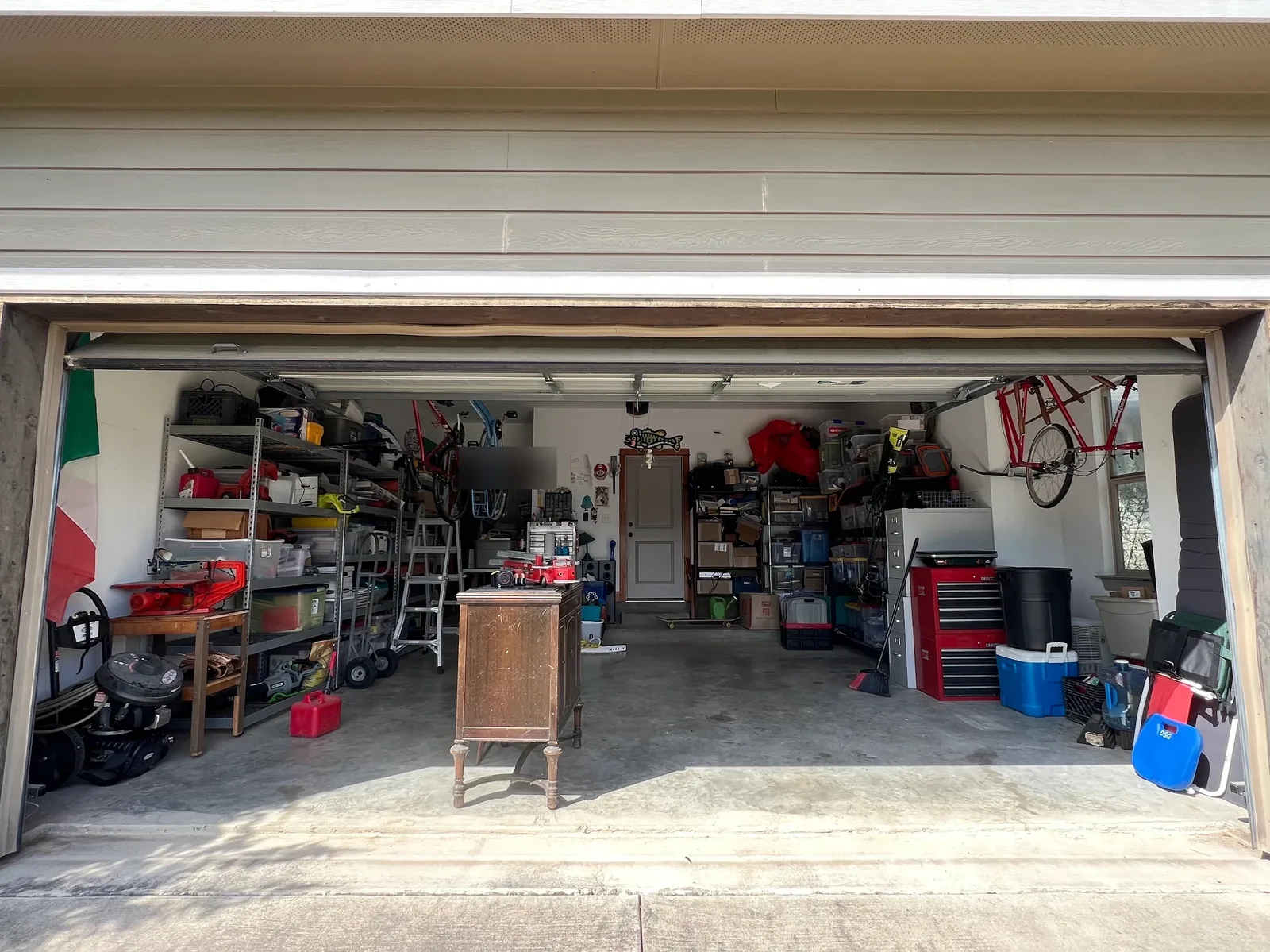 Two-car garage in Austin with clear floor and organized shelves after cleanout